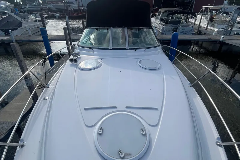 Slide: The Image of 2006 Four Winns 318 Vista boat docked at marina, front deck view. - 11