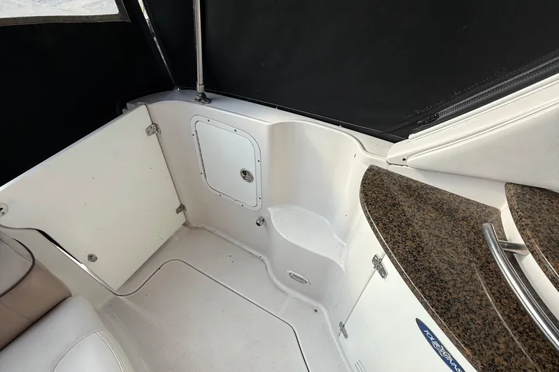 Slide: The Image of 2006 Four Winns 318 Vista boat interior with white seating and granite countertop. - 14