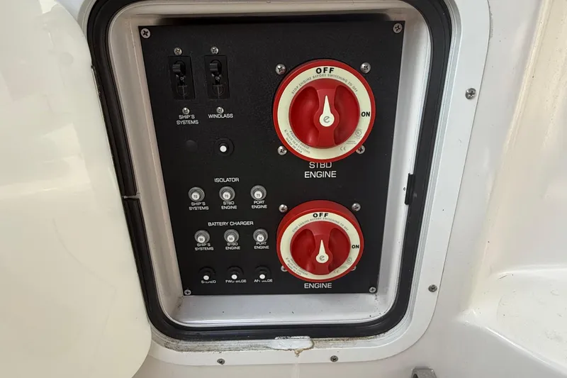 Slide: The Image of Control panel of a 2006 Four Winns 318 Vista boat with engine switches. - 16