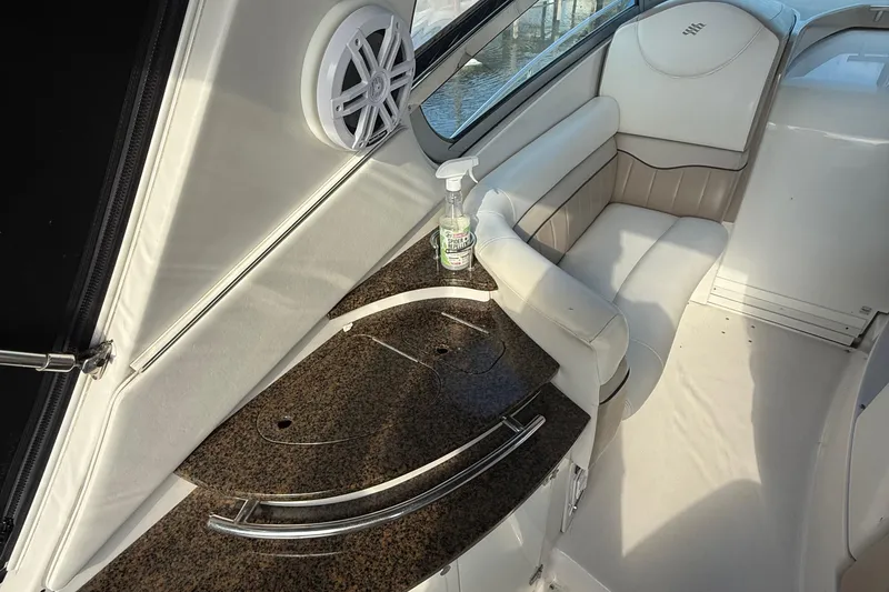 Slide: The Image of 2006 Four Winns 318 Vista boat interior with white seating and granite countertop. - 17
