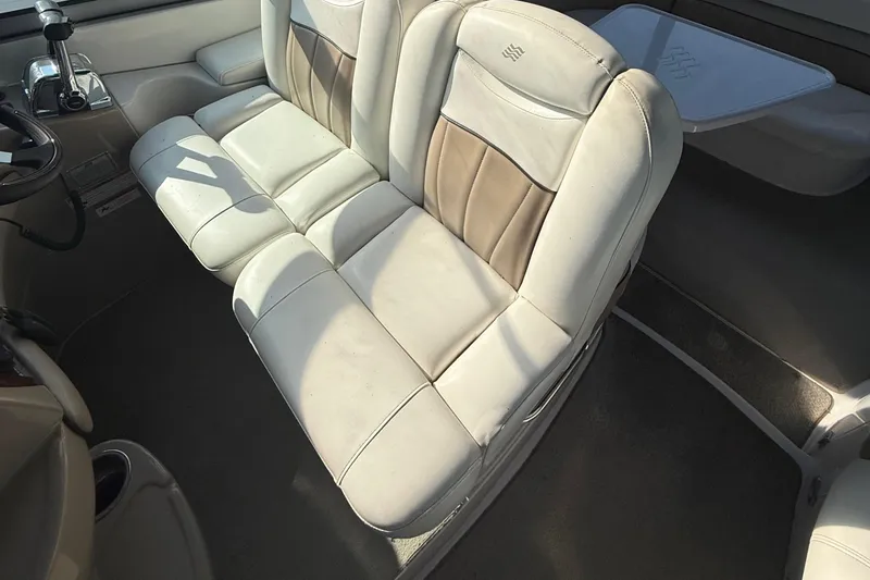 Slide: The Image of 2006 Four Winns 318 Vista boat interior with beige leather seating and table. - 18