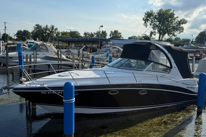 Slide: The Image of 2006 Four Winns 318 Vista boat docked at marina, sunny day, calm water. - 2