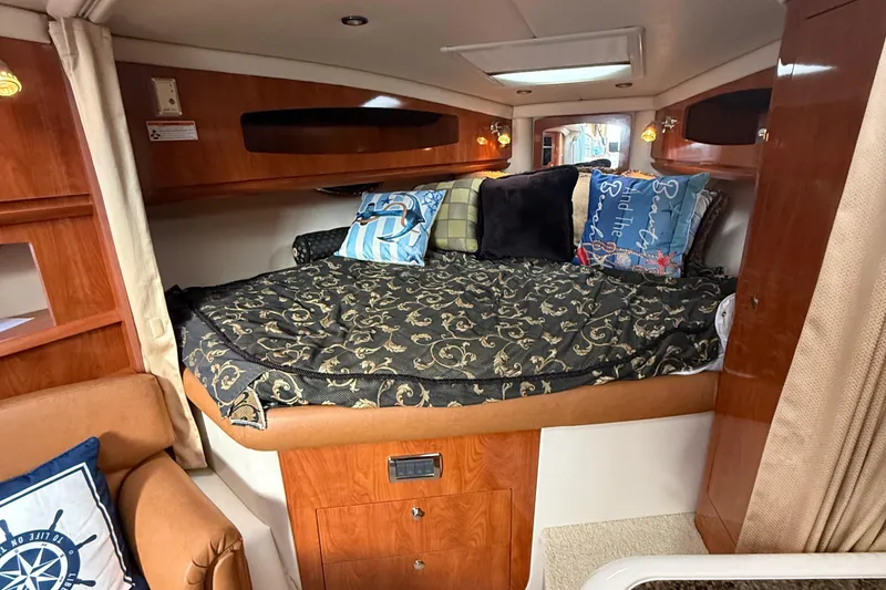 Slide: The Image of Cozy cabin interior of 2006 Four Winns 318 Vista with decorative pillows and wood paneling. - 22