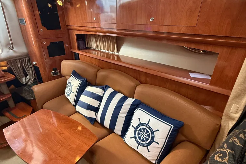 Slide: The Image of Luxurious 2006 Four Winns 318 Vista yacht interior with plush seating and nautical-themed cushions. - 23