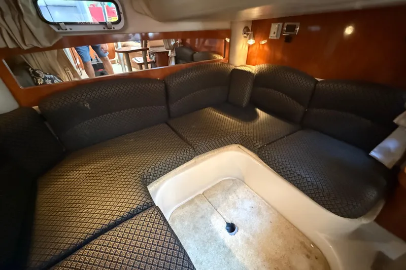 Slide: The Image of Interior of 2006 Four Winns 318 Vista boat with plush seating and wood accents. - 29