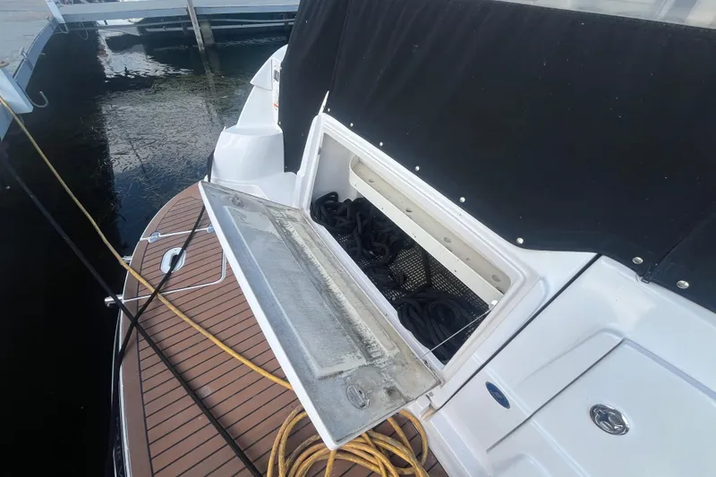 Slide: The Image of 2006 Four Winns 318 Vista boat with open storage compartment at dock. - 8