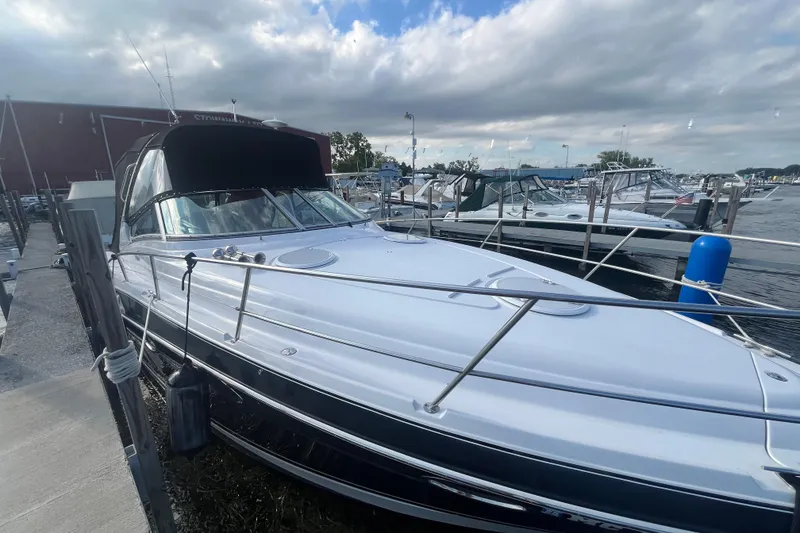 Slide: The Image of 2006 Four Winns 318 Vista boat docked at marina under cloudy sky. - 9