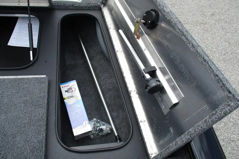 Slide: The Image of 2026 Tracker Pro Team 175 Crappie Edition boat storage compartment with accessories. - 14