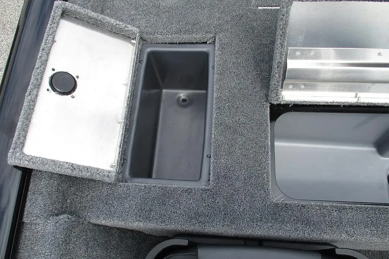 Slide: The Image of 2026 Tracker Pro Team 175 Crappie Edition boat storage compartments, featuring carpeted interior. - 21