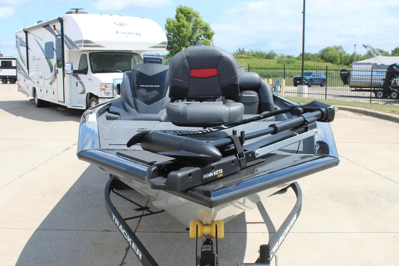 Slide: The Image of 2026 Tracker Pro Team 175 boat with Minn Kota motor, parked near an RV. - 2