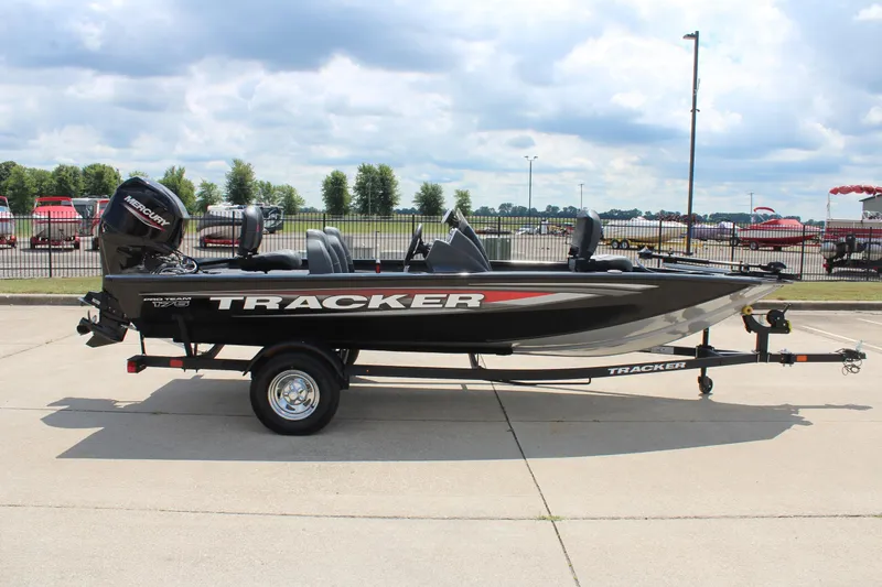 Slide: The Image of 2026 Tracker Pro Team 175 boat on trailer, parked outdoors under cloudy sky. - 4