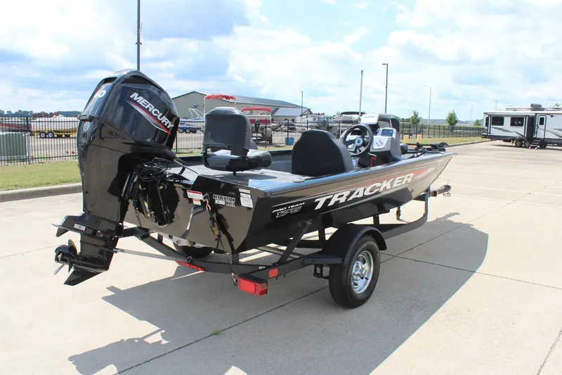 Slide: The Image of 2026 Tracker Pro Team 175 boat with Mercury engine on a trailer in a parking lot. - 5