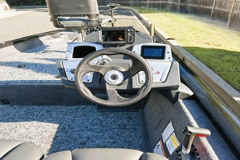 Slide: The Image of 2026 Tracker Pro Team 175 Crappie Edition boat dashboard with steering wheel and controls. - 5