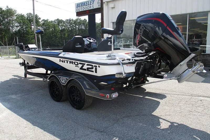 Slide: The Image of 2026 Nitro Z21 XL Pro boat with powerful engine, parked outdoors. - 2