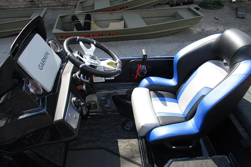 Slide: The Image of 2026 Nitro Z21 XL Pro boat cockpit with Garmin display and blue-accented seat. - 27