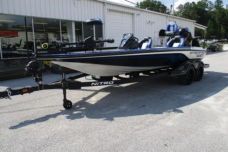 Slide: The Image of 2026 Nitro Z21 XL Pro boat on trailer, parked outside a building. - 3