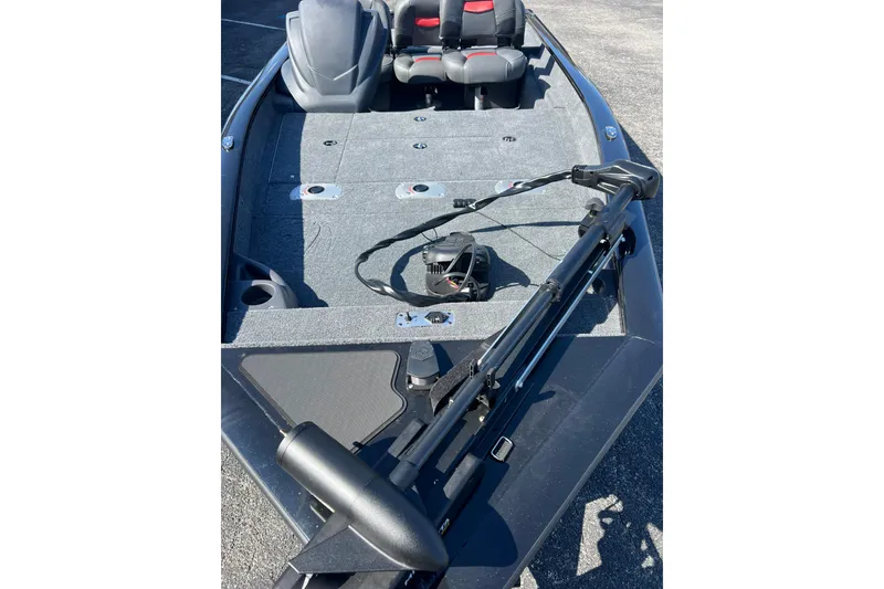 Slide: The Image of 2026 Tracker Pro Team 175 Crappie Edition boat interior with fishing rod holders. - 5