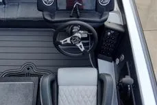 Slide: The Image of 2026 Phoenix 818 Pro boat interior with steering wheel and dashboard controls. - 6