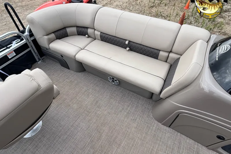 Slide: The Image of 2023 Sun Tracker SportFish 20 DLX interior with beige seating and carpeted flooring. - 10
