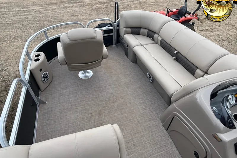 Slide: The Image of 2023 Sun Tracker SportFish 20 DLX pontoon boat interior with beige seating and steering console. - 11