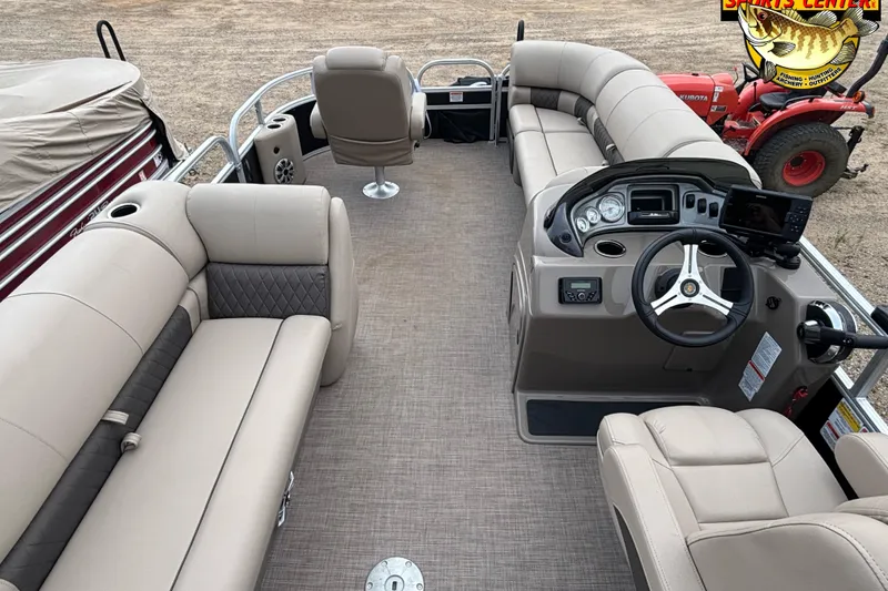 Slide: The Image of 2023 Sun Tracker SportFish 20 DLX pontoon boat interior with beige seating and steering console. - 13