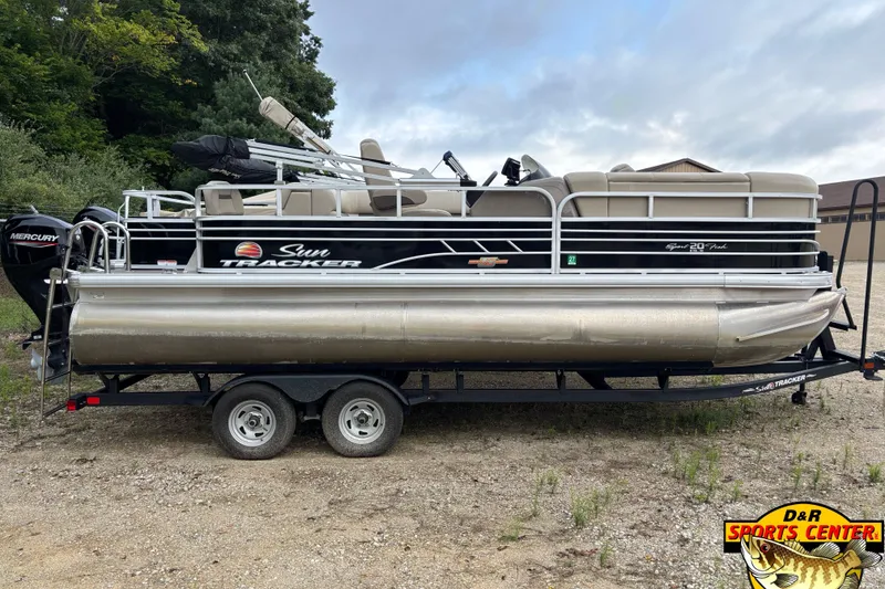 Slide: The Image of 2023 Sun Tracker SportFish 20 DLX pontoon boat on trailer, side view. - 2