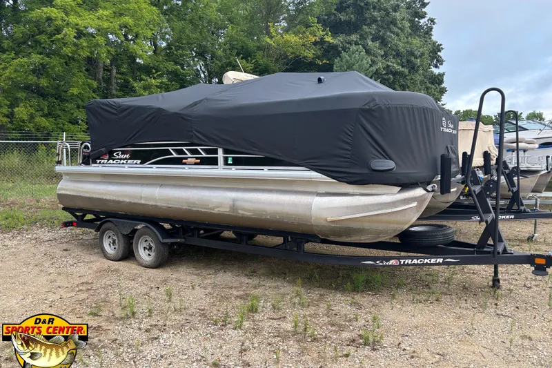 Slide: The Image of 2023 Sun Tracker SportFish 20 DLX pontoon boat on trailer, covered, outdoors. - 5