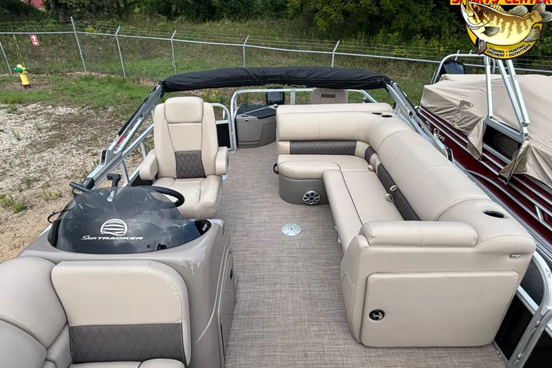 Slide: The Image of 2023 Sun Tracker SportFish 20 DLX pontoon boat with beige seating and steering console. - 6
