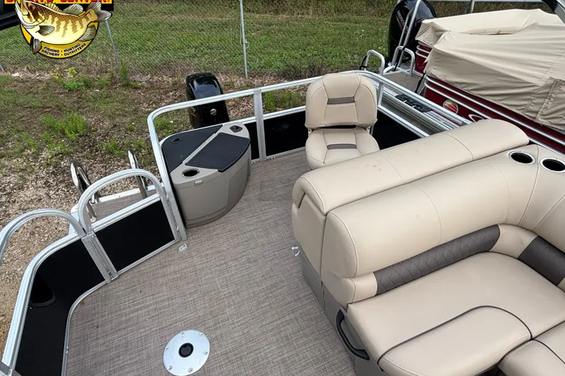 Slide: The Image of 2023 Sun Tracker SportFish 20 DLX pontoon boat interior with beige seating and fishing station. - 7