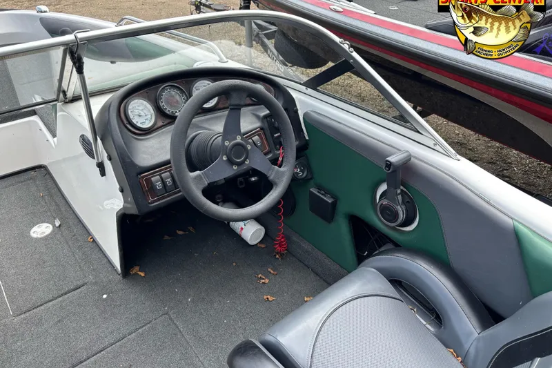 Slide: The Image of 2002 Skeeter SL 190 boat interior with steering wheel and dashboard controls. - 5