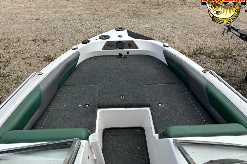 Slide: The Image of 2002 Skeeter SL 190 boat interior with green seating and gray carpet. - 7