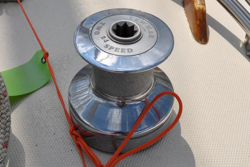 Slide: The Image of Winch on 1984 Sabre 38 MKI sailboat deck with red rope and Lewmar branding. - 10