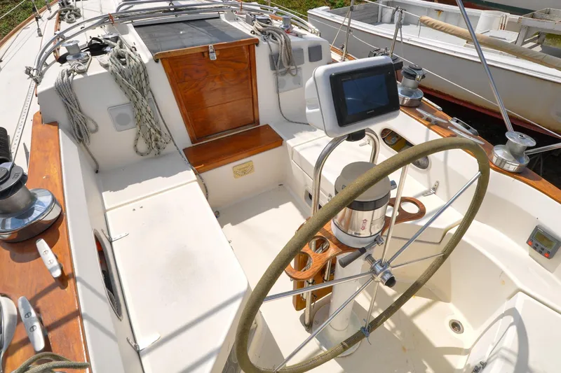 Slide: The Image of 1984 Sabre 38 MKI sailboat cockpit with steering wheel and navigation equipment. - 14