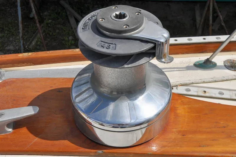 Slide: The Image of Chrome winch on 1984 Sabre 38 MKI sailboat deck, wooden and metal details visible. - 17