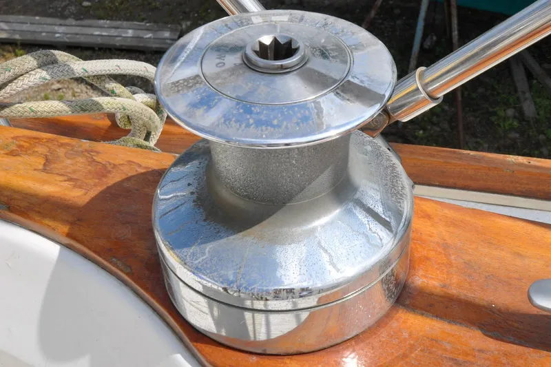 Slide: The Image of Chrome winch on 1984 Sabre 38 MKI sailboat deck with wooden finish and rope. - 18