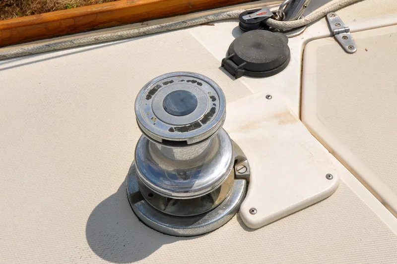 Slide: The Image of Chrome winch on 1984 Sabre 38 MKI sailboat deck, with rope and fittings. - 31