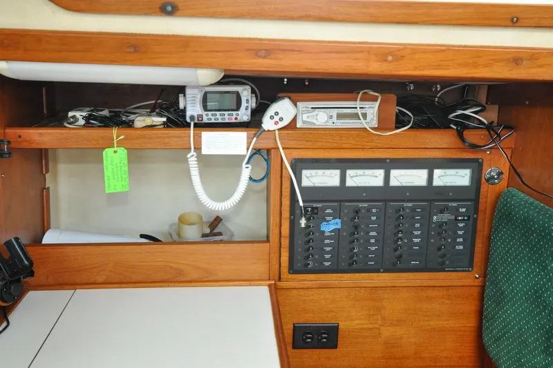Slide: The Image of 1984 Sabre 38 MKI yacht electrical panel with gauges and communication equipment. - 38