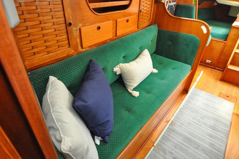 Slide: The Image of Cozy interior of 1984 Sabre 38 MKI sailboat with green cushioned seating and pillows. - 46