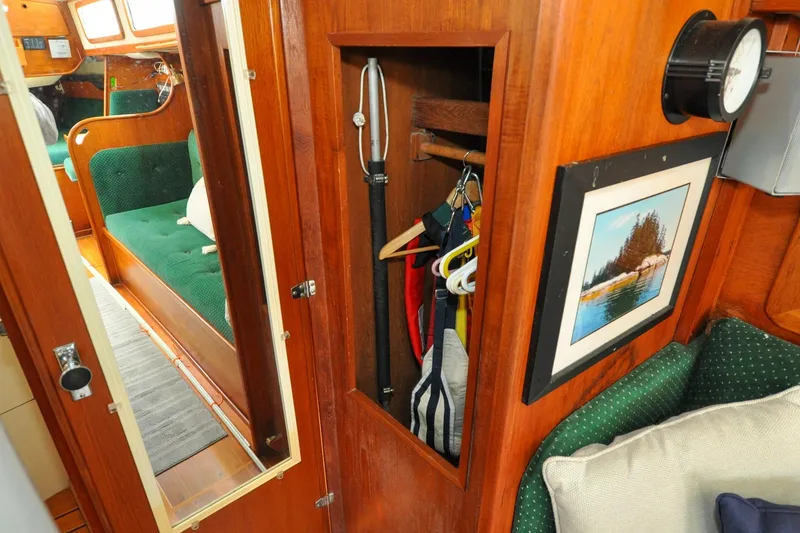 Slide: The Image of Interior of 1984 Sabre 38 MKI sailboat with wooden cabinetry and green seating. - 48