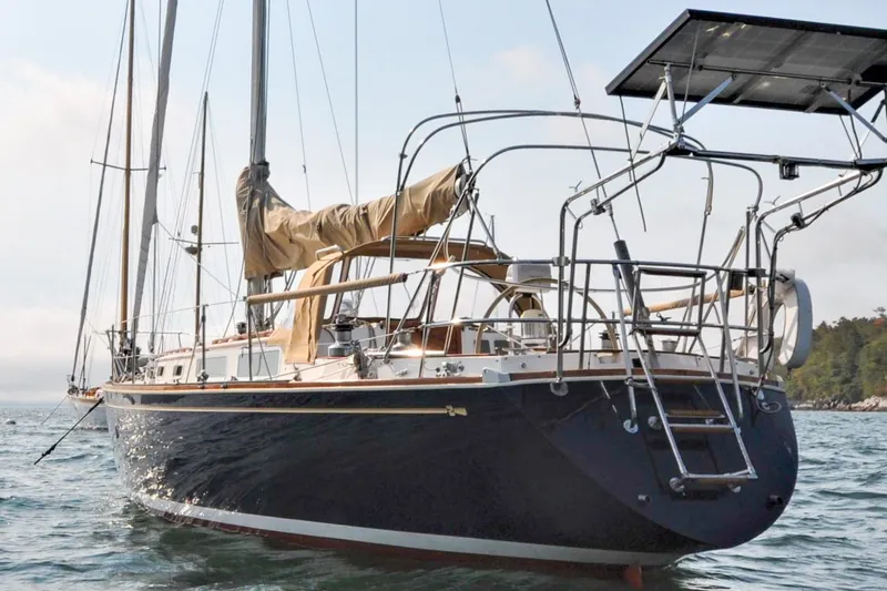 Slide: The Image of 1984 Sabre 38 MKI sailboat on water, featuring sleek design and solar panels. - 5