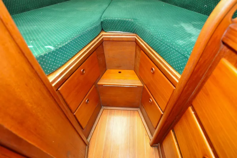 Slide: The Image of Interior of 1984 Sabre 38 MKI sailboat with wooden cabinetry and green cushioned berth. - 50