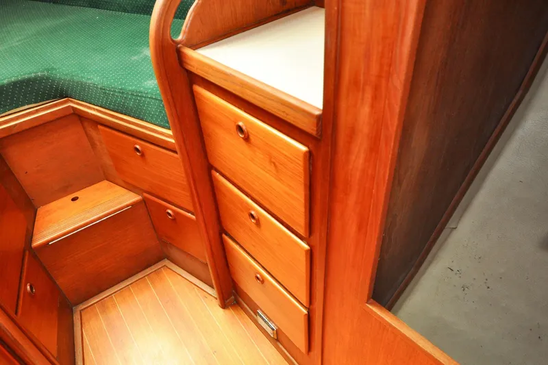 Slide: The Image of Interior of 1984 Sabre 38 MKI sailboat with wooden cabinetry and green upholstery. - 52