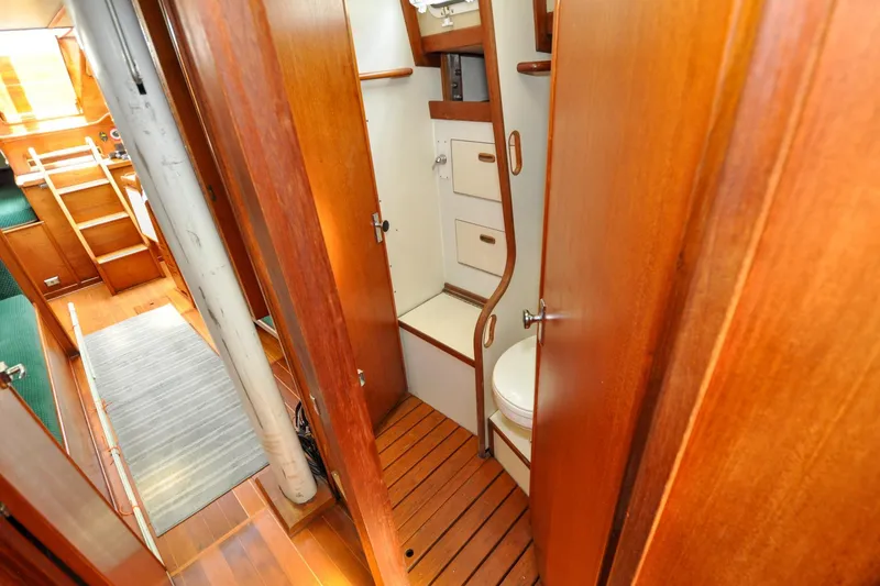 Slide: The Image of 1984 Sabre 38 MKI yacht interior with wooden cabinetry and compact bathroom. - 57