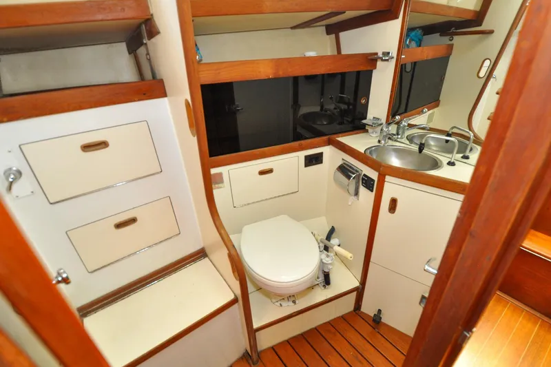 Slide: The Image of 1984 Sabre 38 MKI yacht bathroom with wooden accents, sink, and toilet. - 58