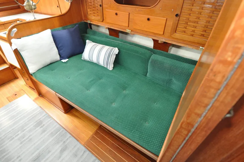 Slide: The Image of Interior of 1984 Sabre 38 MKI sailboat with green cushioned seating and pillows. - 66