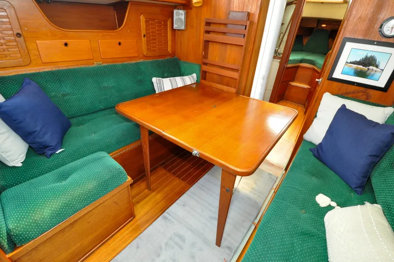 Slide: The Image of Interior of 1984 Sabre 38 MKI sailboat with wooden table and green seating. - 71