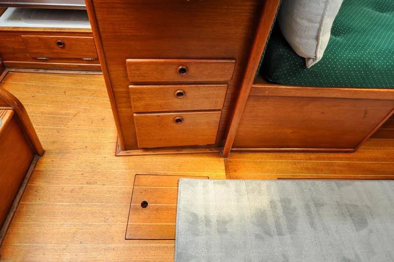 Slide: The Image of 1984 Sabre 38 MKI interior with wooden cabinetry and green cushioned seating. - 75