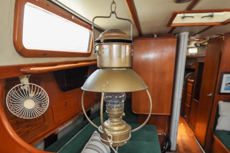 Slide: The Image of Interior of 1984 Sabre 38 MKI sailboat with vintage brass lantern and wooden furnishings. - 76