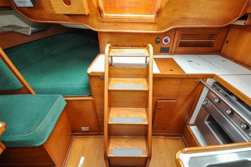 Slide: The Image of Interior of 1984 Sabre 38 MKI sailboat with wooden cabinetry and compact kitchen. - 83