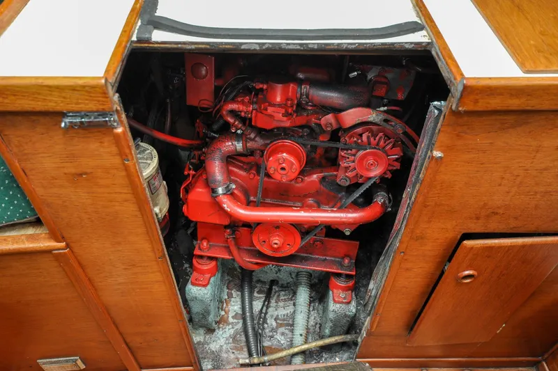Slide: The Image of Engine compartment of a 1984 Sabre 38 MKI sailboat, featuring a red marine engine. - 84
